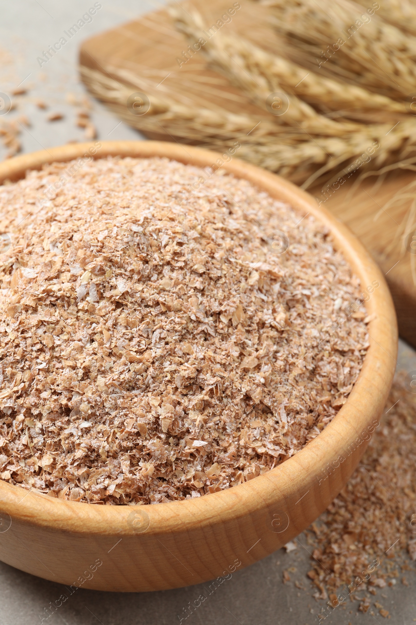 Photo of Wheat bran in bowl on table, closeup