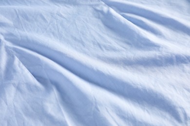 Crumpled light blue fabric as background, closeup view