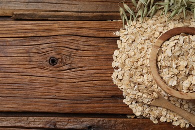 Oatmeal and florets on wooden table, flat lay. Space for text