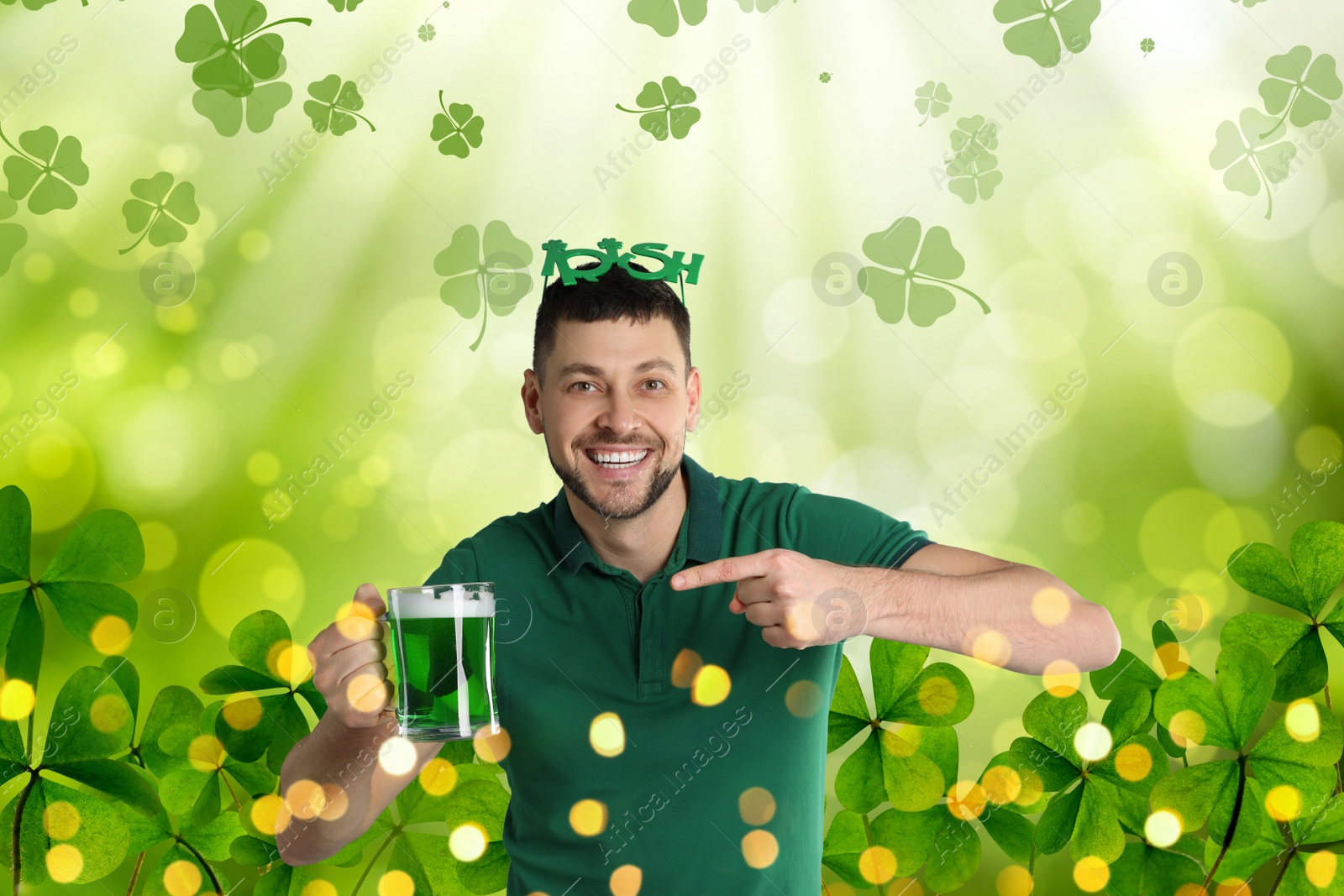 Image of Happy man in St. Patrick's Day outfit with beer on green background