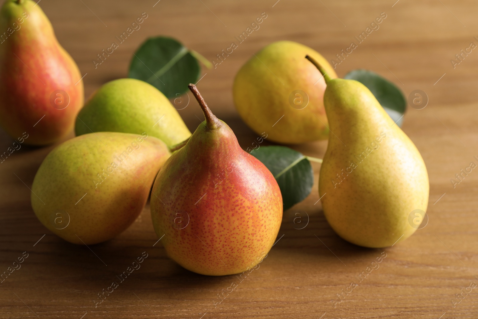 Photo of Ripe pears on wooden table. Healthy snack