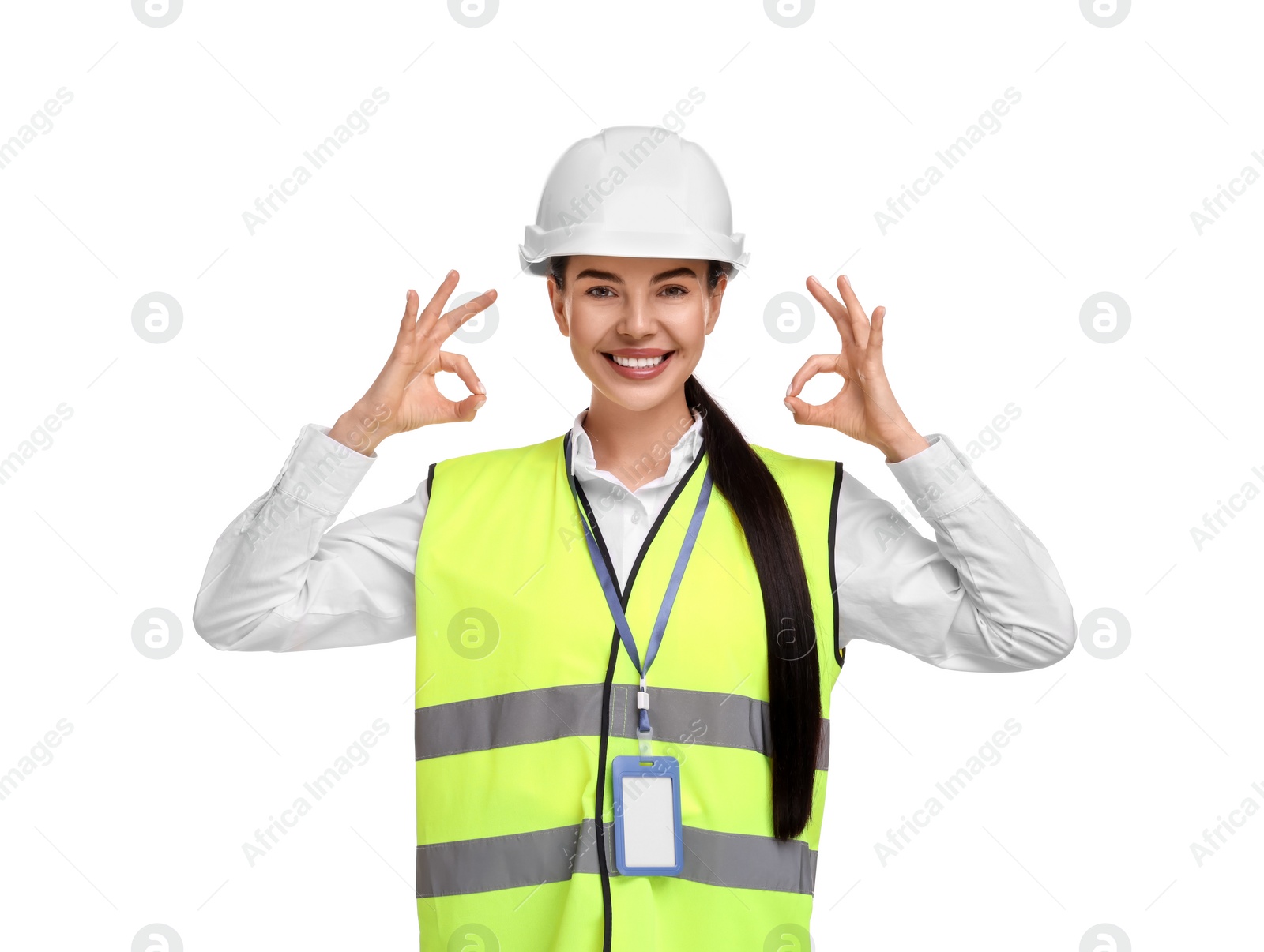 Photo of Engineer with hard hat and badge showing ok gesture on white background