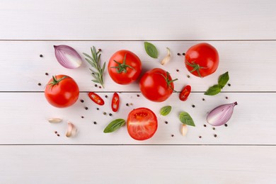 Photo of Flat lay composition with whole and cut tomatoes on white wooden table