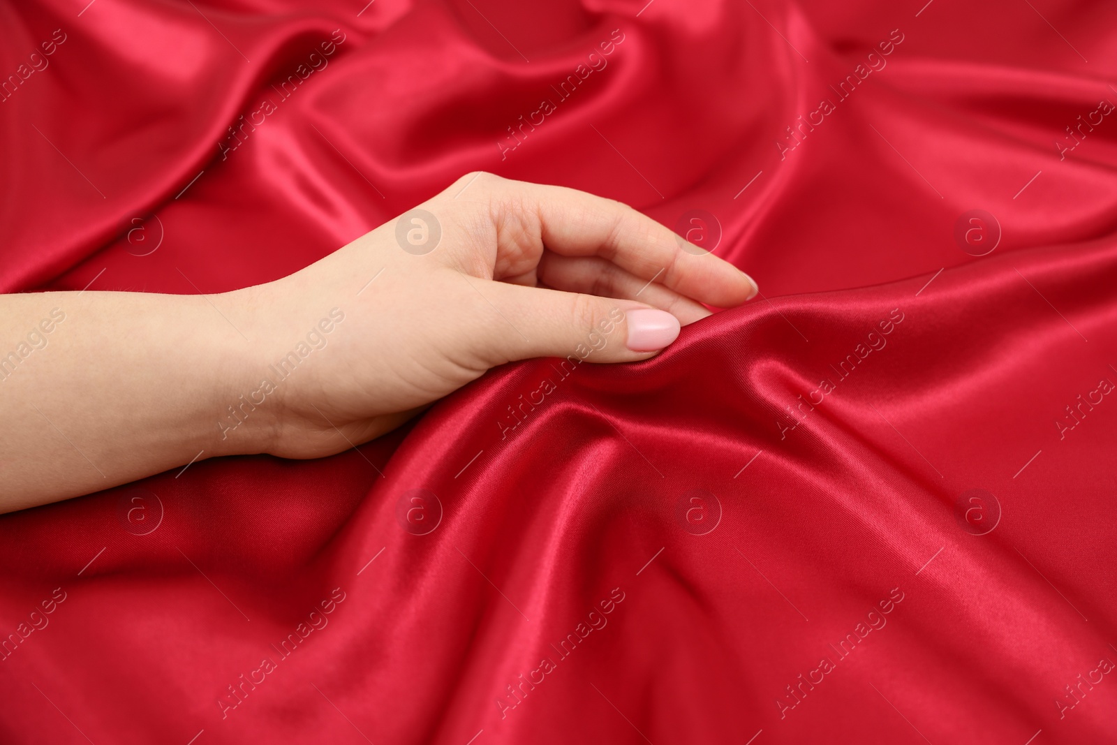 Photo of Woman touching smooth silky fabric, closeup view