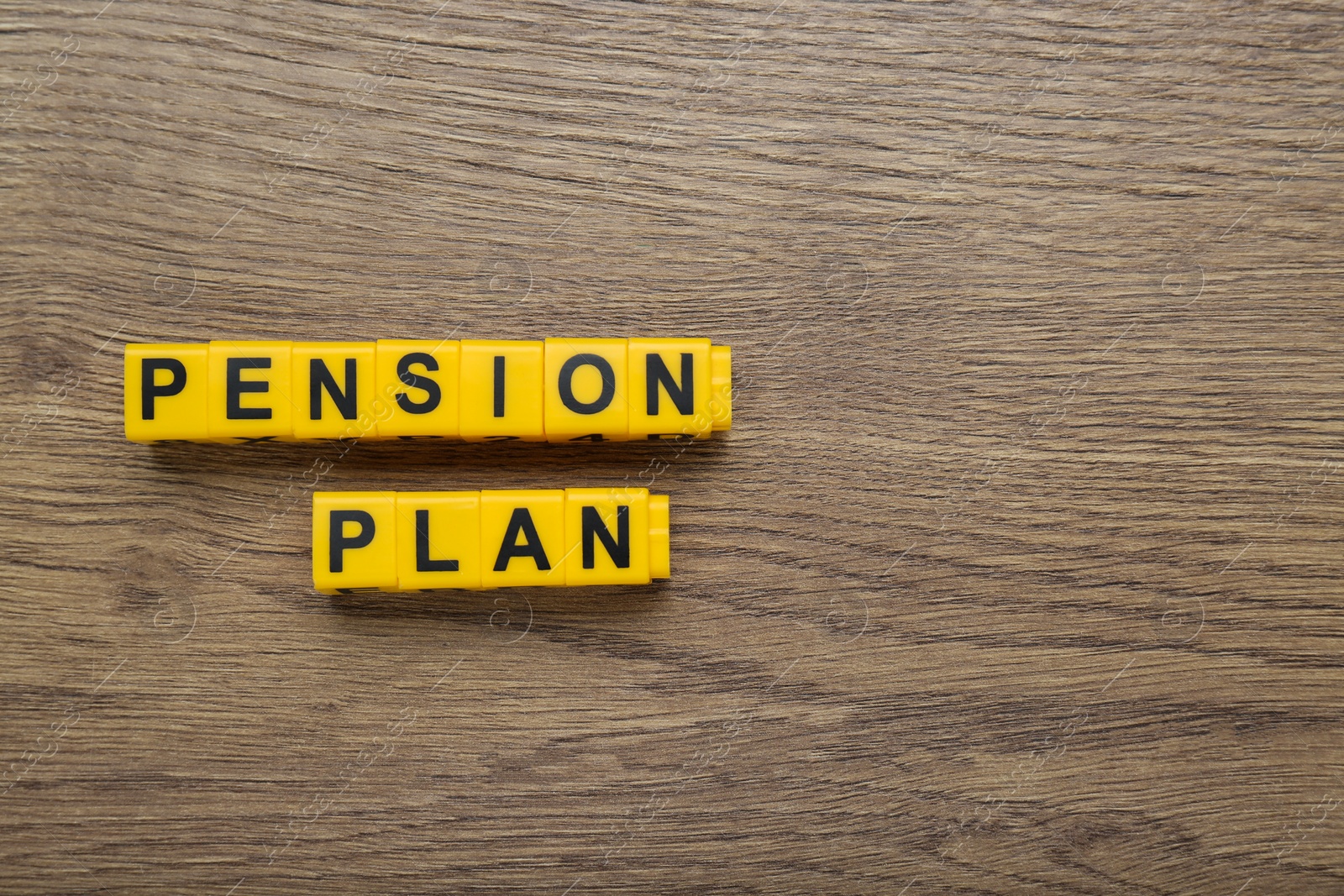 Photo of Words Pension Plan made of yellow cubes on wooden table, flat lay. Space for text
