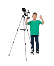 Photo of Cute little boy with telescope showing ok gesture on white background