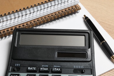 Photo of Calculator, pen and notebooks, closeup. Tax accounting