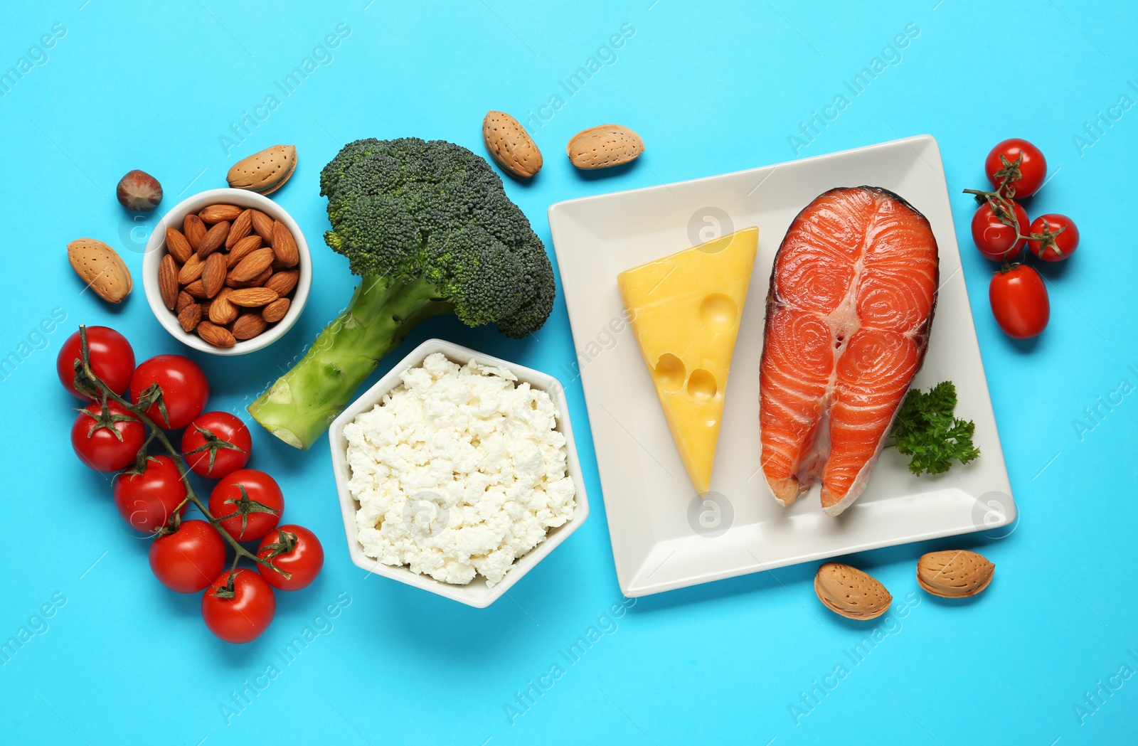 Photo of Set of fresh products on light blue background, flat lay. Keto diet