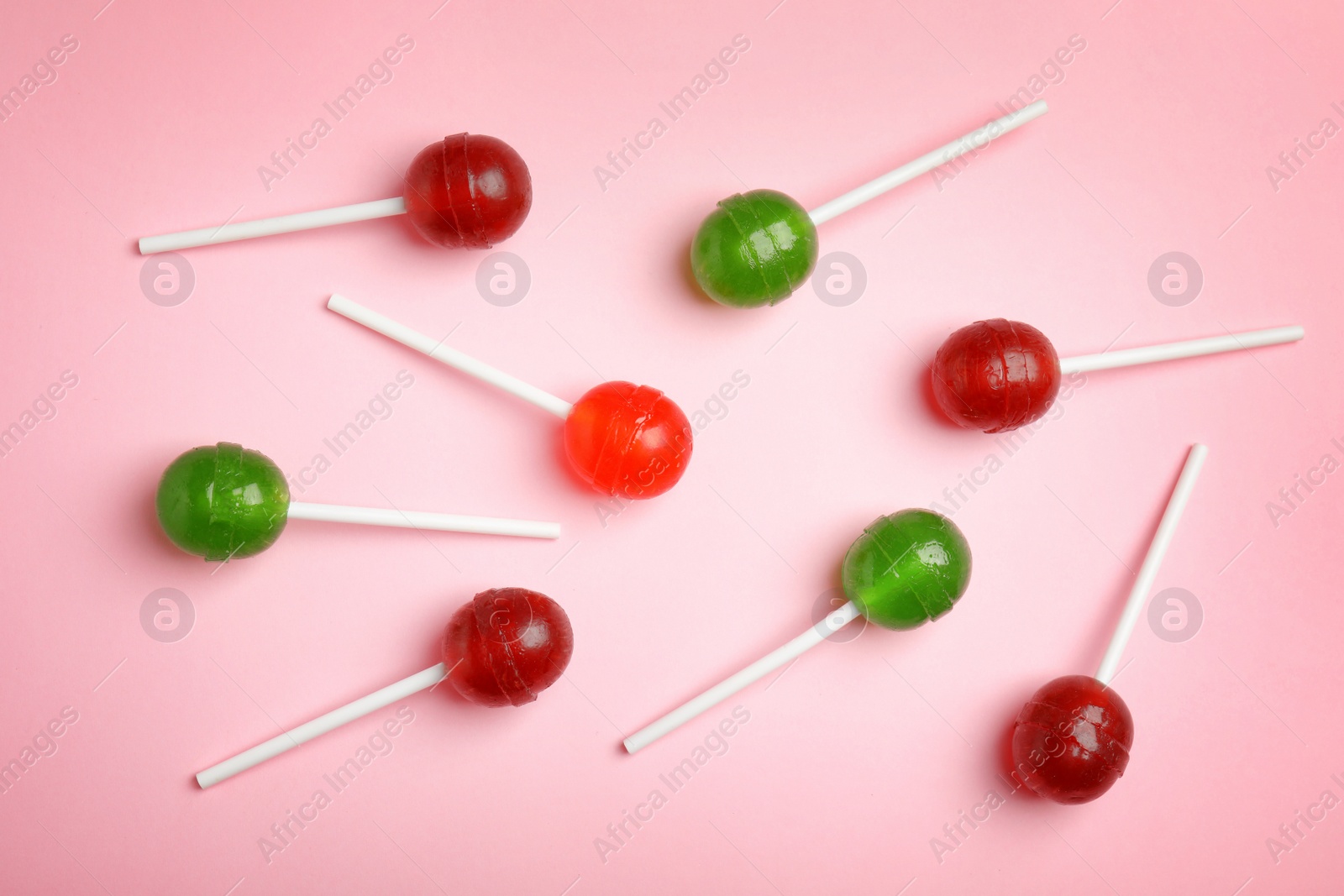 Photo of Flat lay composition with delicious colorful candies on color background