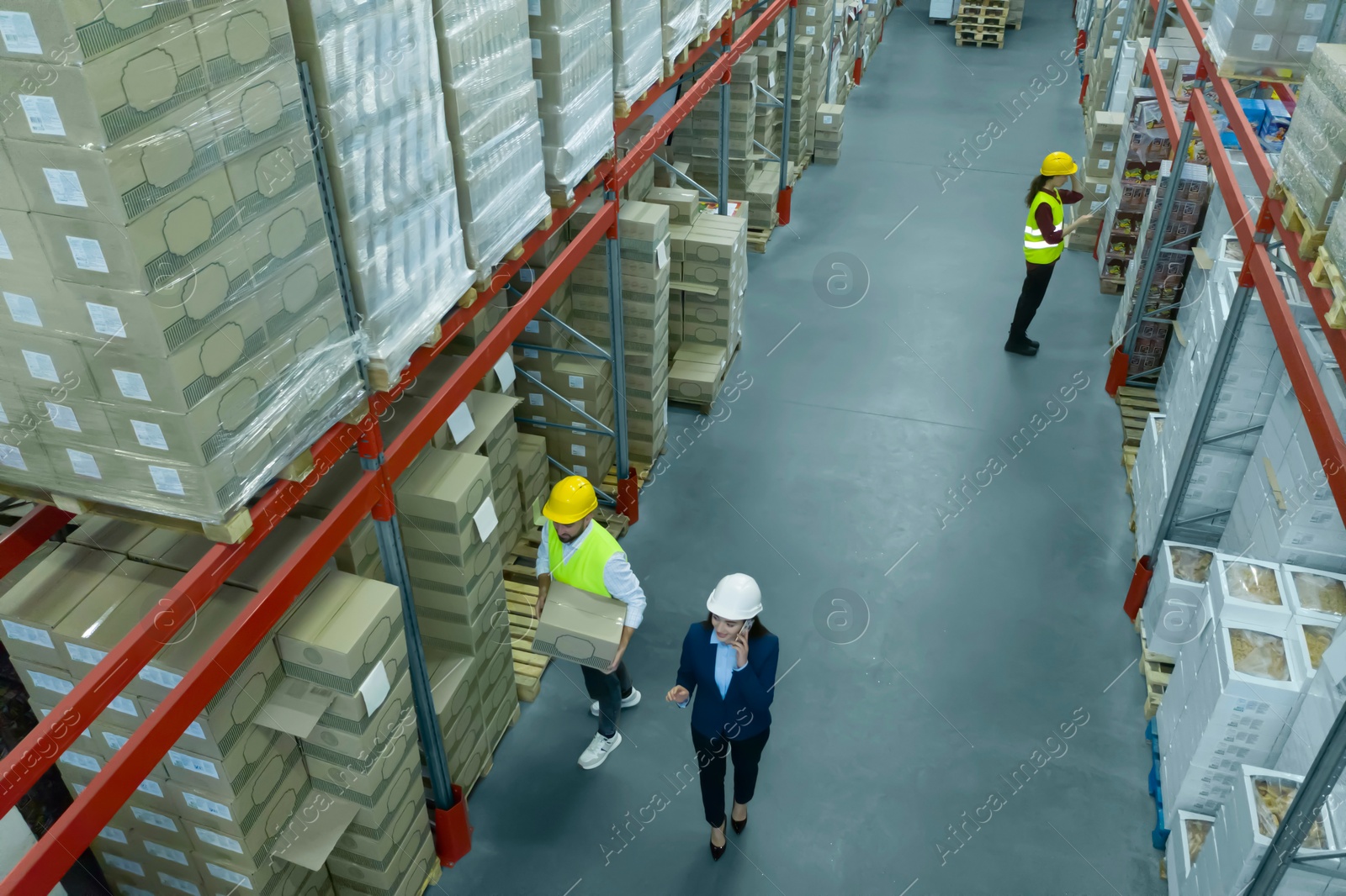 Image of Manager and workers at warehouse, above view. Logistics center