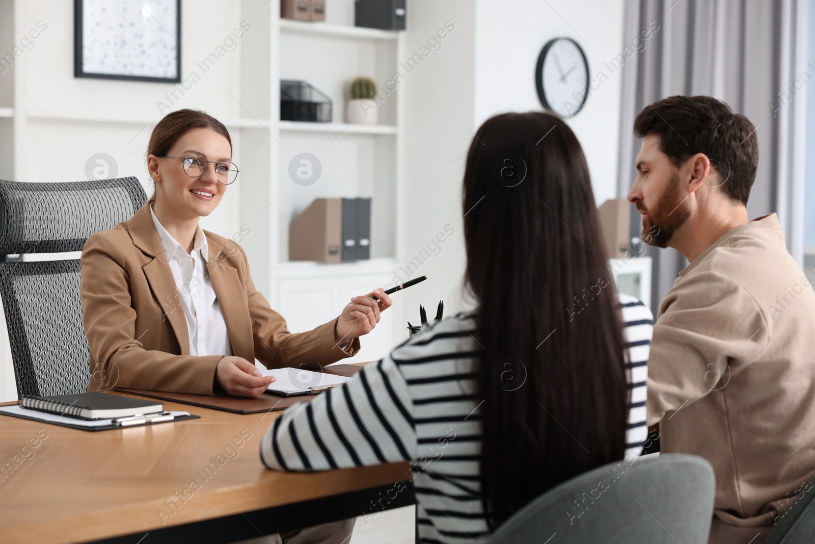 Photo of Couple having meeting with lawyer in office