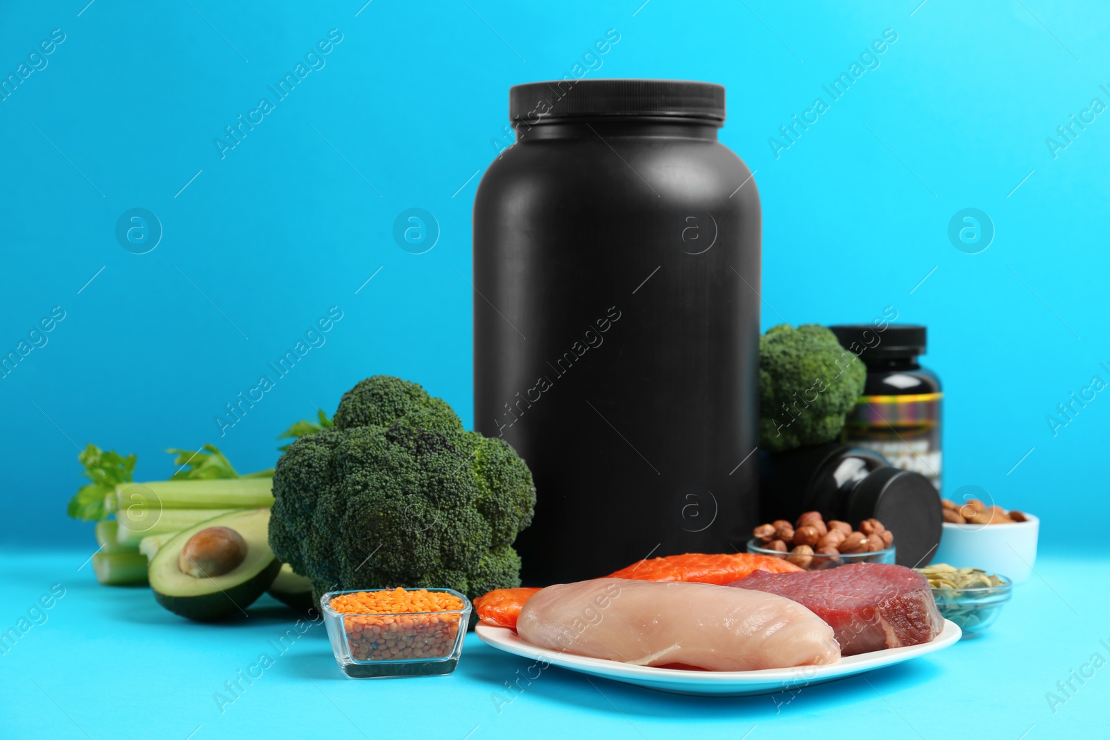 Photo of Set of products rich in amino acids and supplements on light blue background