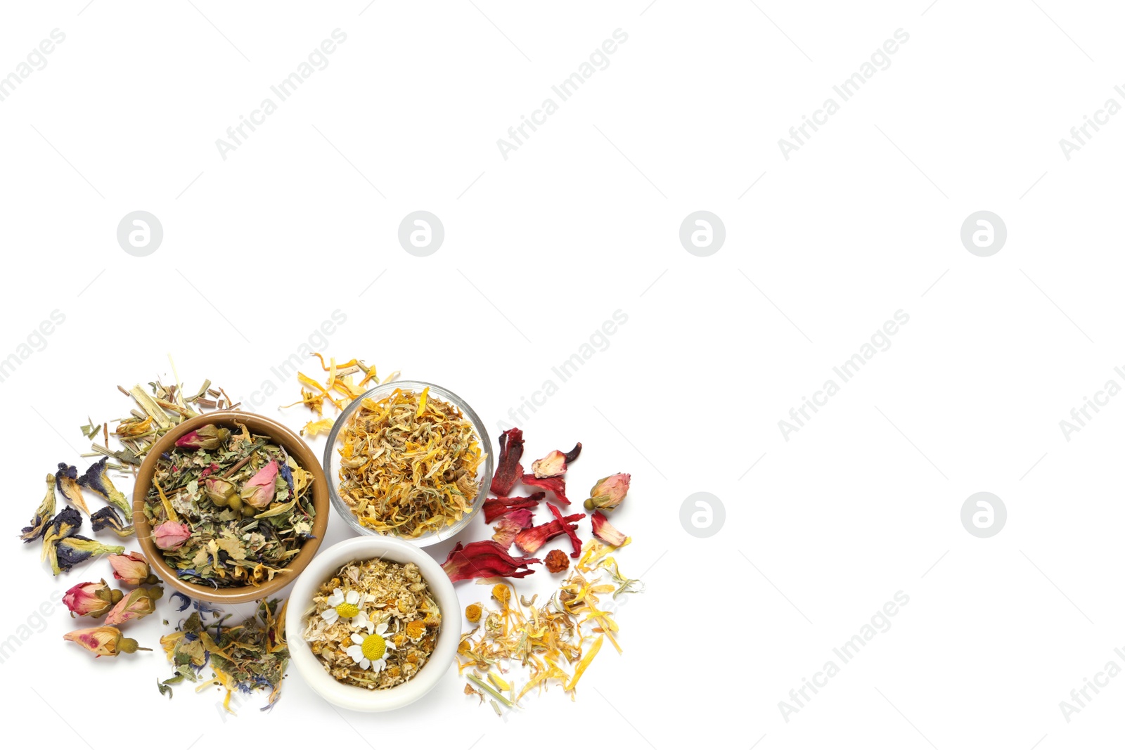 Photo of Different dry herbal teas on white background, top view