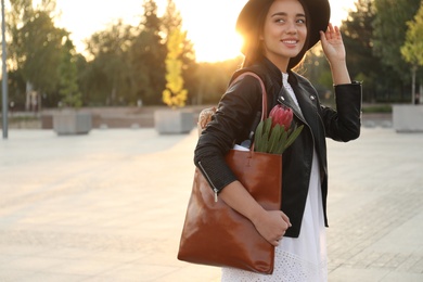 Photo of Woman with stylish leather shopper bag on city street