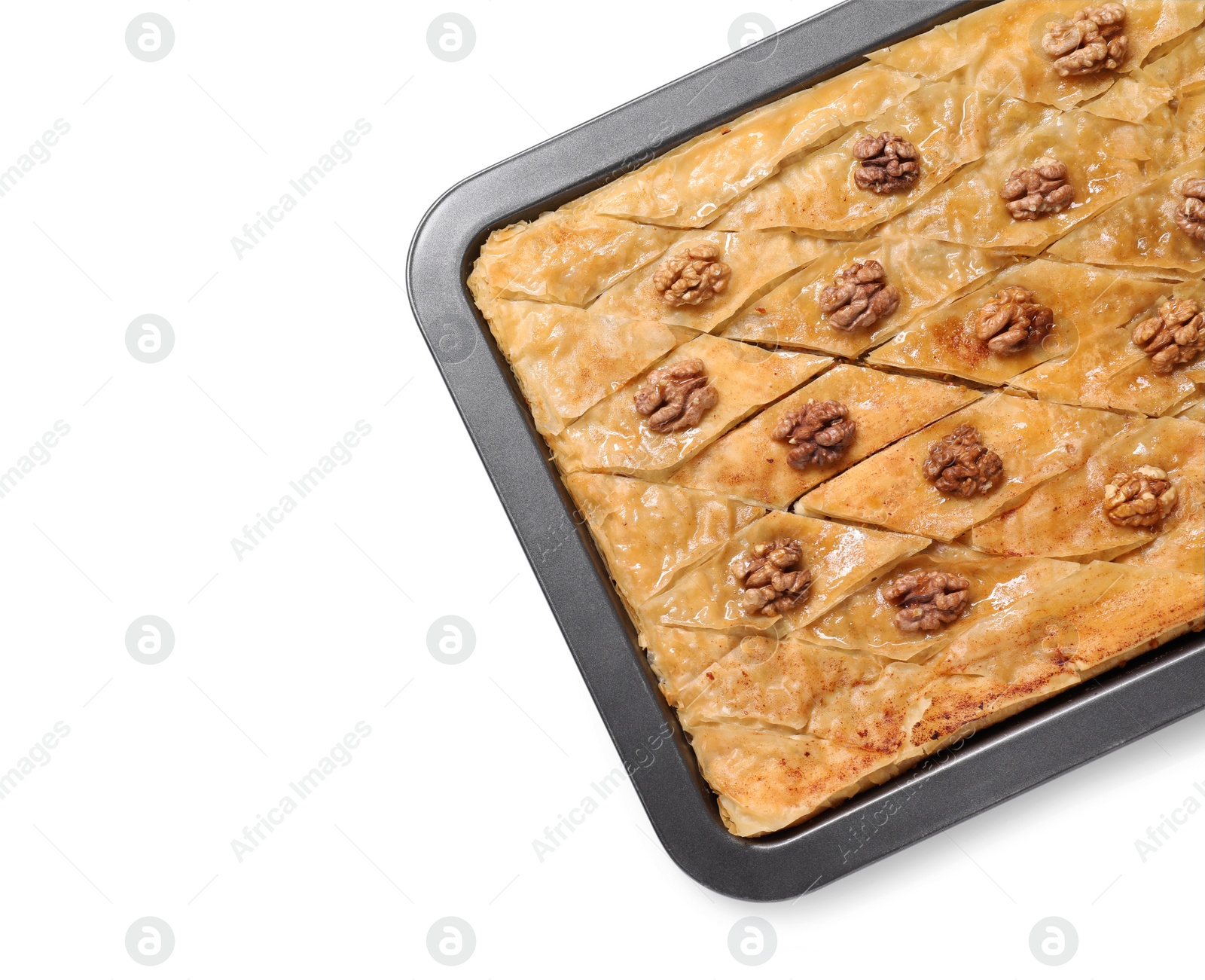 Photo of Delicious baklava with walnuts in baking pan isolated on white, top view