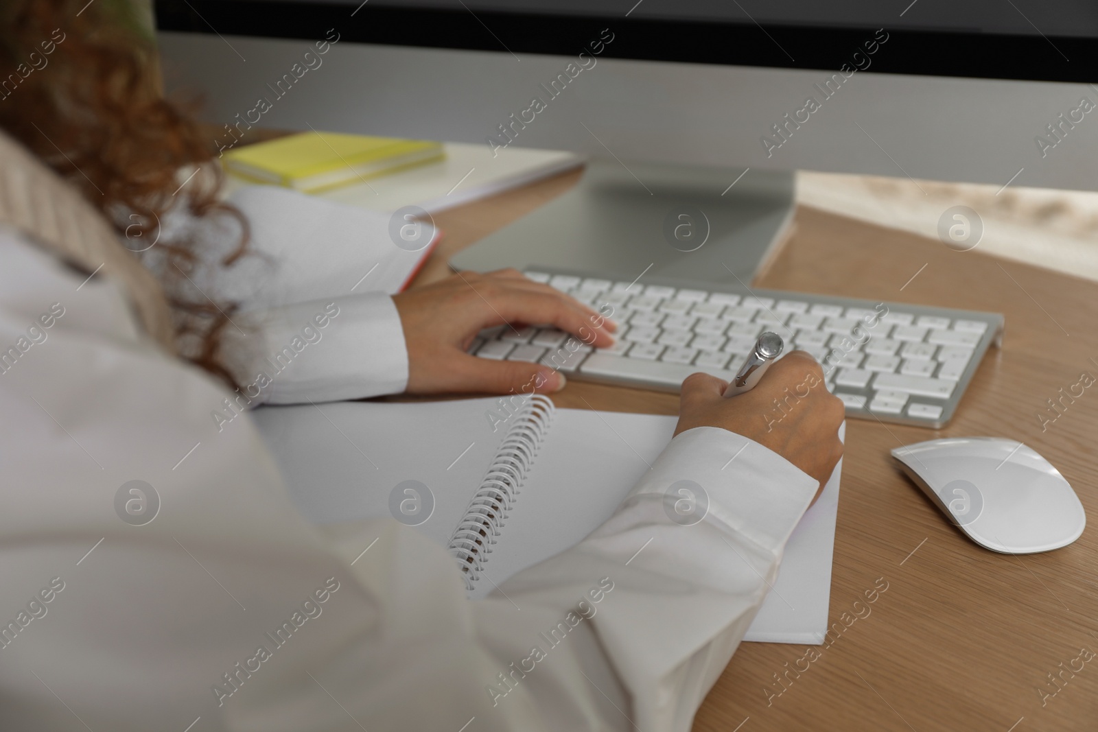 Photo of African American woman studying at table indoors, closeup. Distance learning