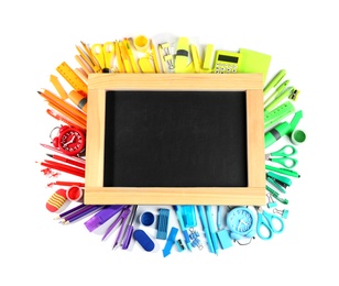 Photo of Composition with different school stationery and blank small chalkboard on white background, top view