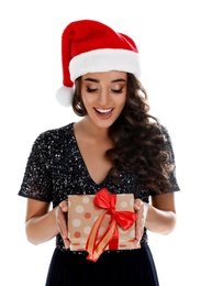 Photo of Beautiful woman in Santa hat with Christmas gift on white background