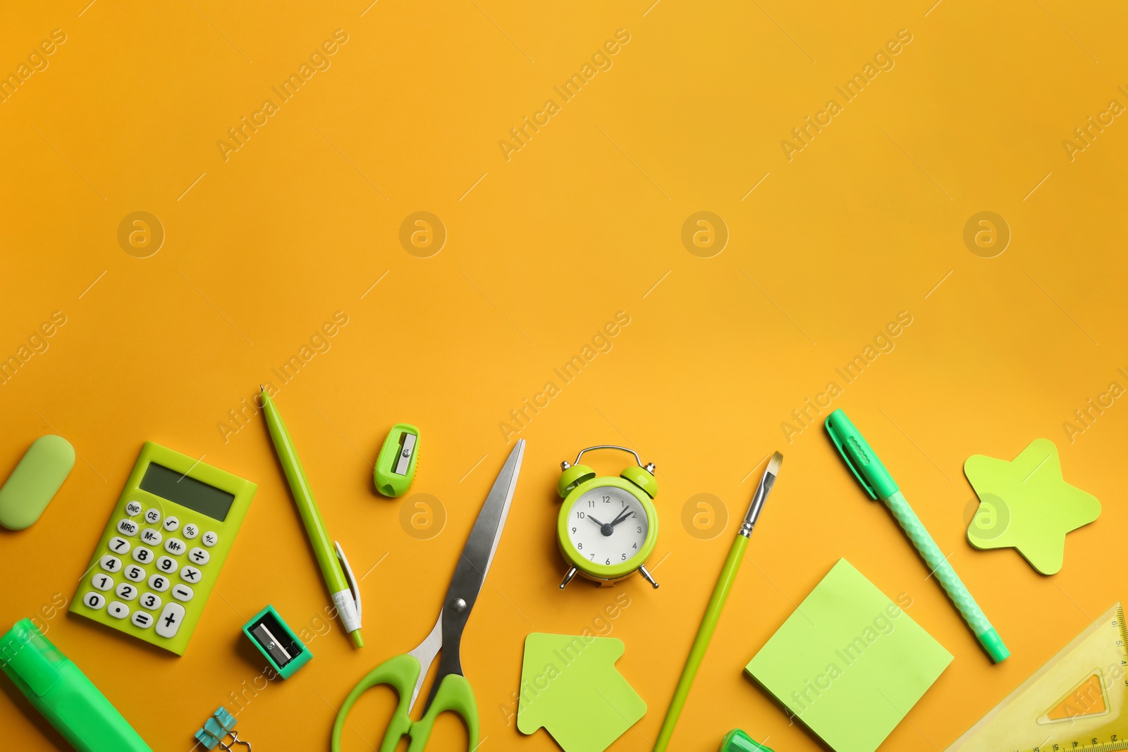 Photo of School stationery on yellow background, flat lay with space for text. Back to school