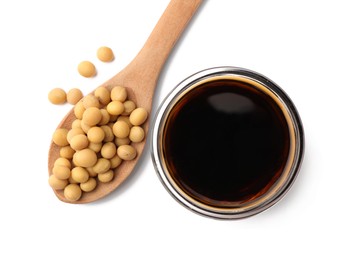 Photo of Bowl of soy sauce and spoon with soybeans isolated on white, top view