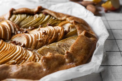 Photo of Delicious apple galette with pecans on table, closeup