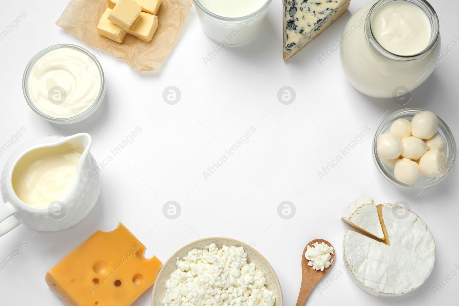 Photo of Frame made with different dairy products on white background, top view. Space for text