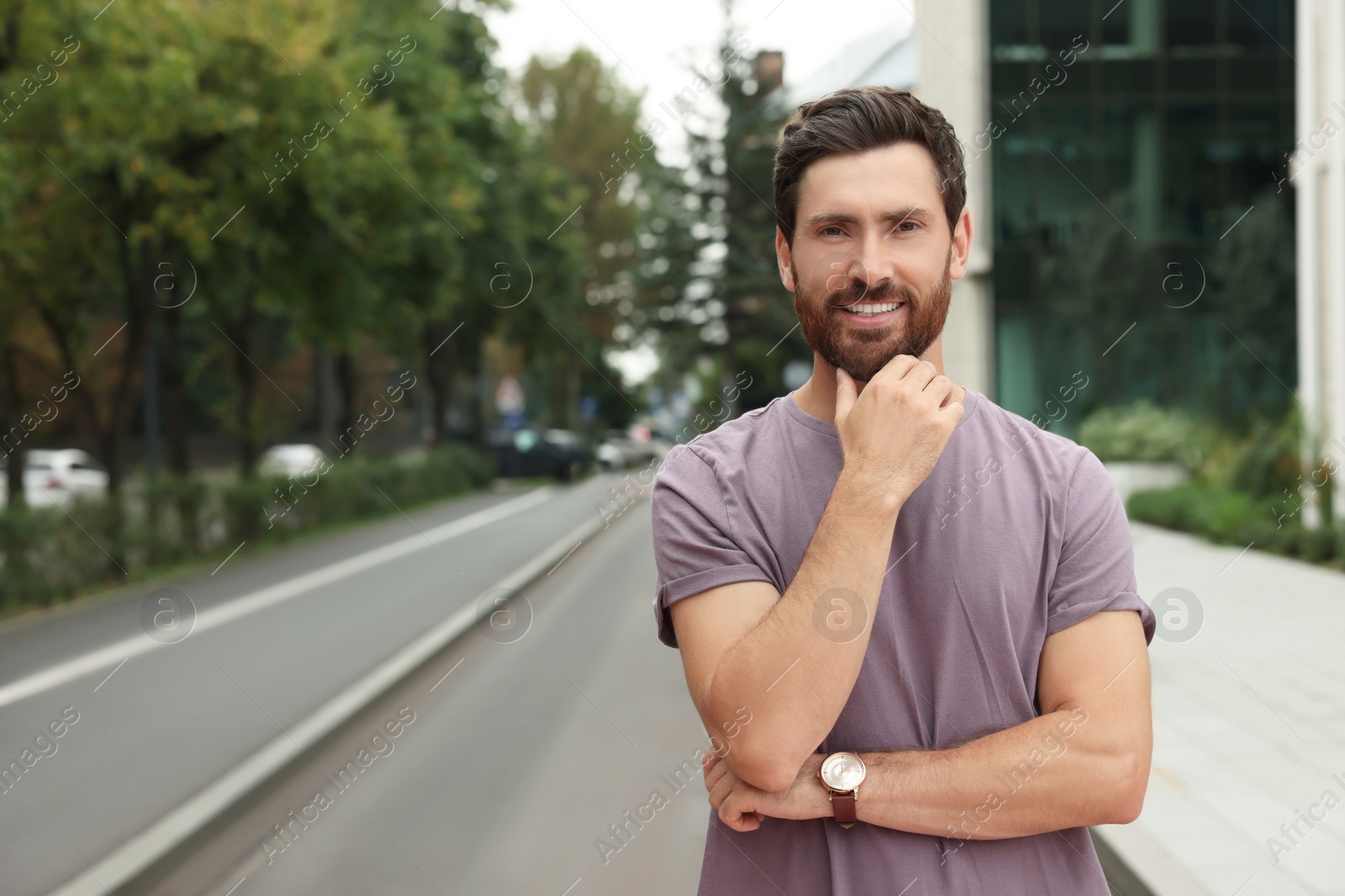 Photo of Portrait of handsome bearded man on street, space for text