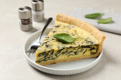 Photo of Piece of delicious spinach pie served on light marble table, closeup