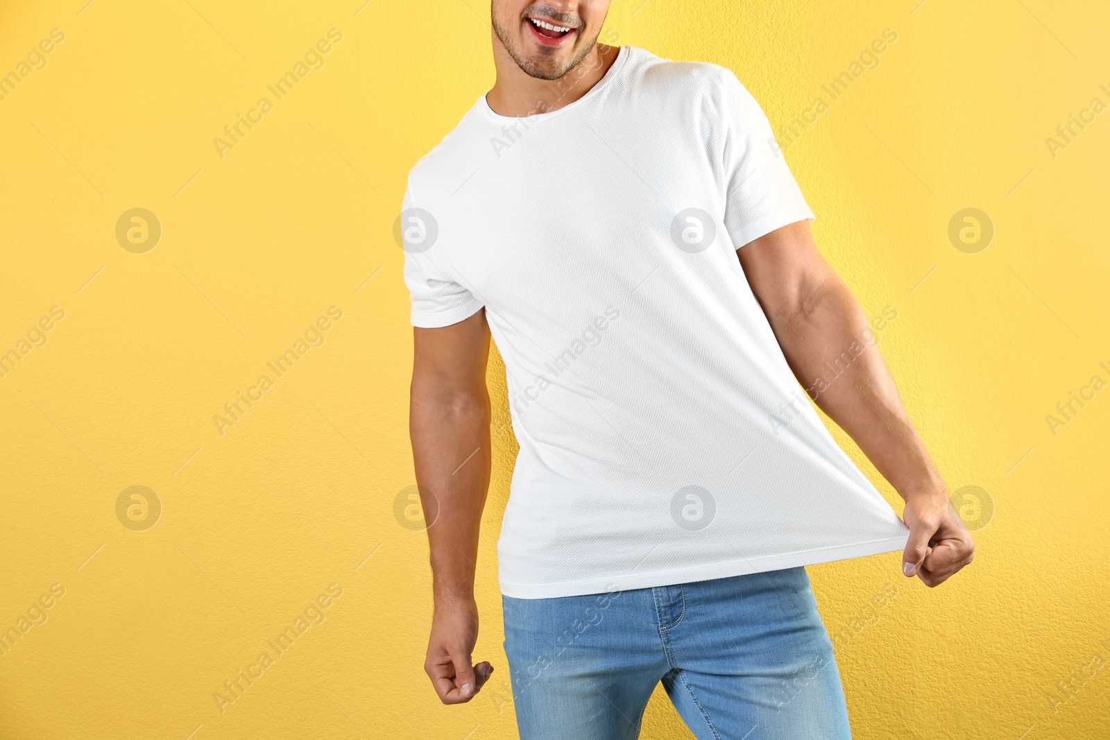 Photo of Young man in t-shirt on color background. Mockup for design