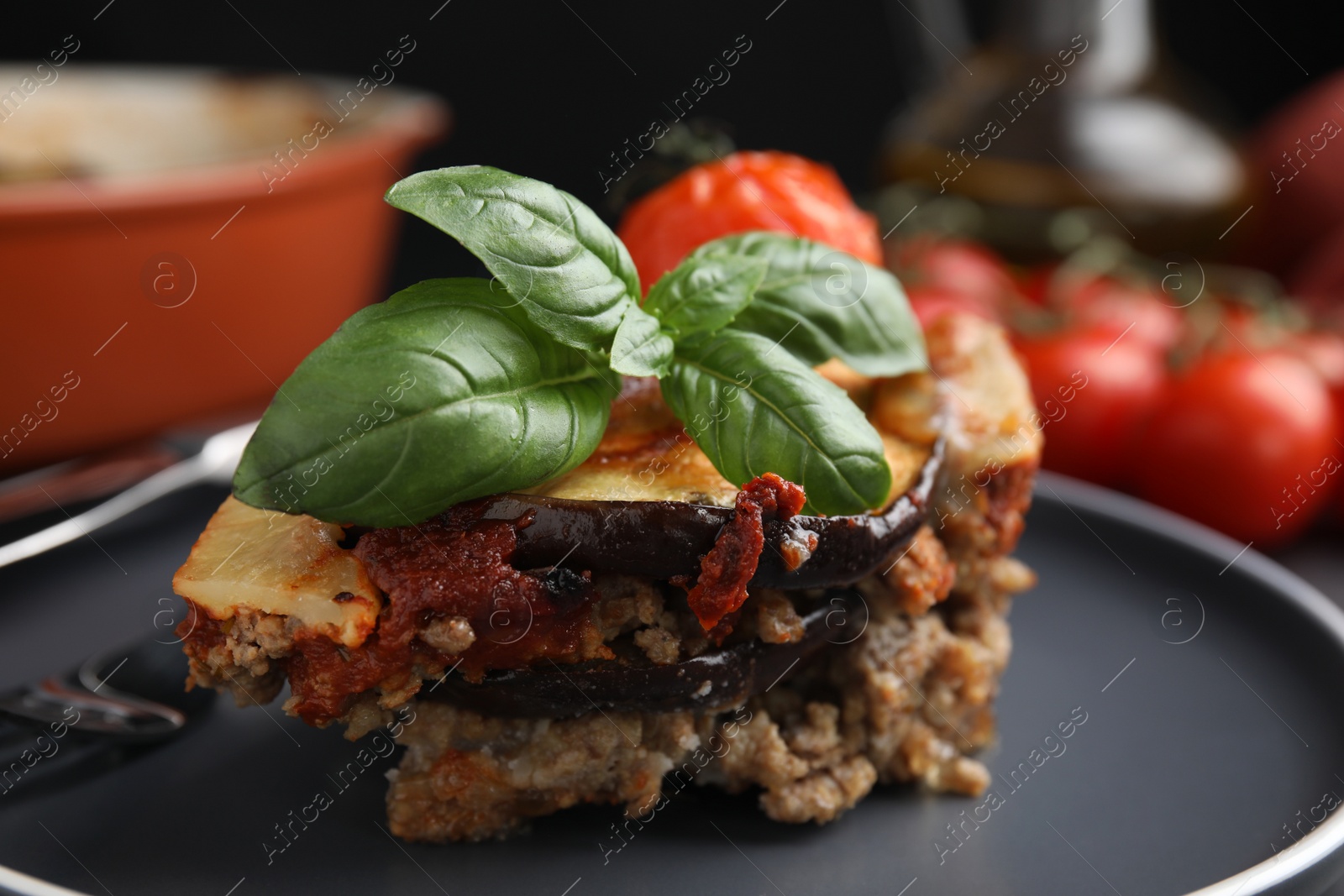 Photo of Grey plate of delicious eggplant lasagna, closeup