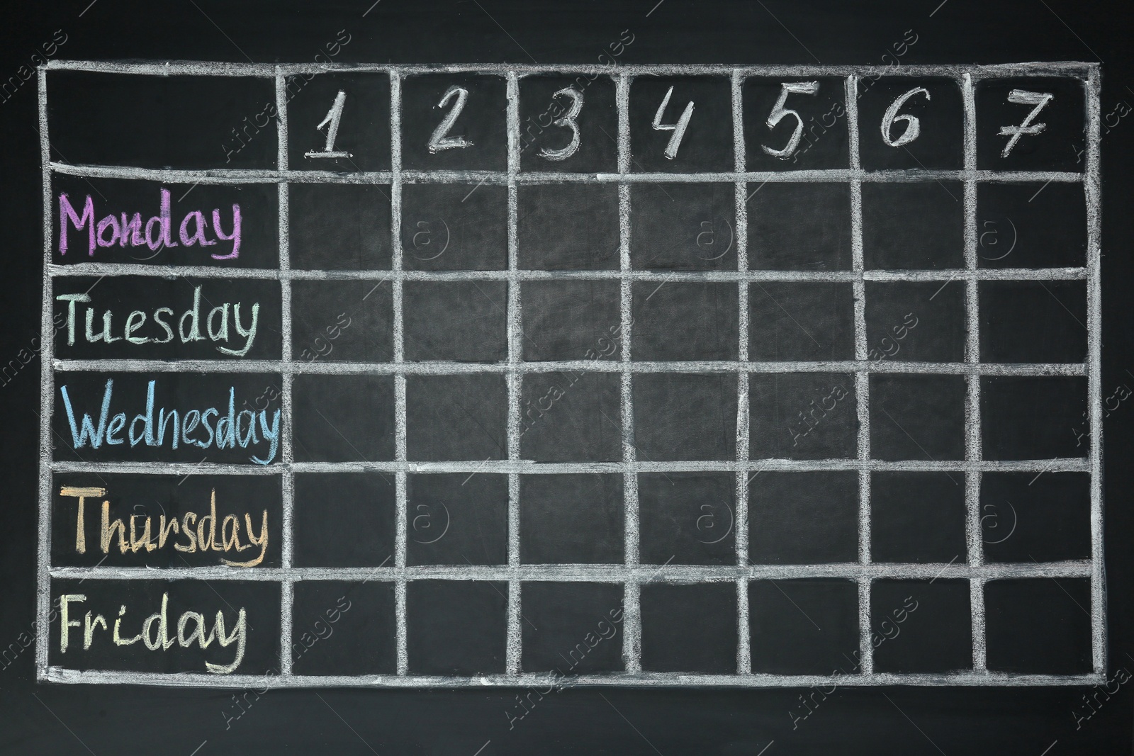 Photo of Weekly school timetable drawn on black chalkboard
