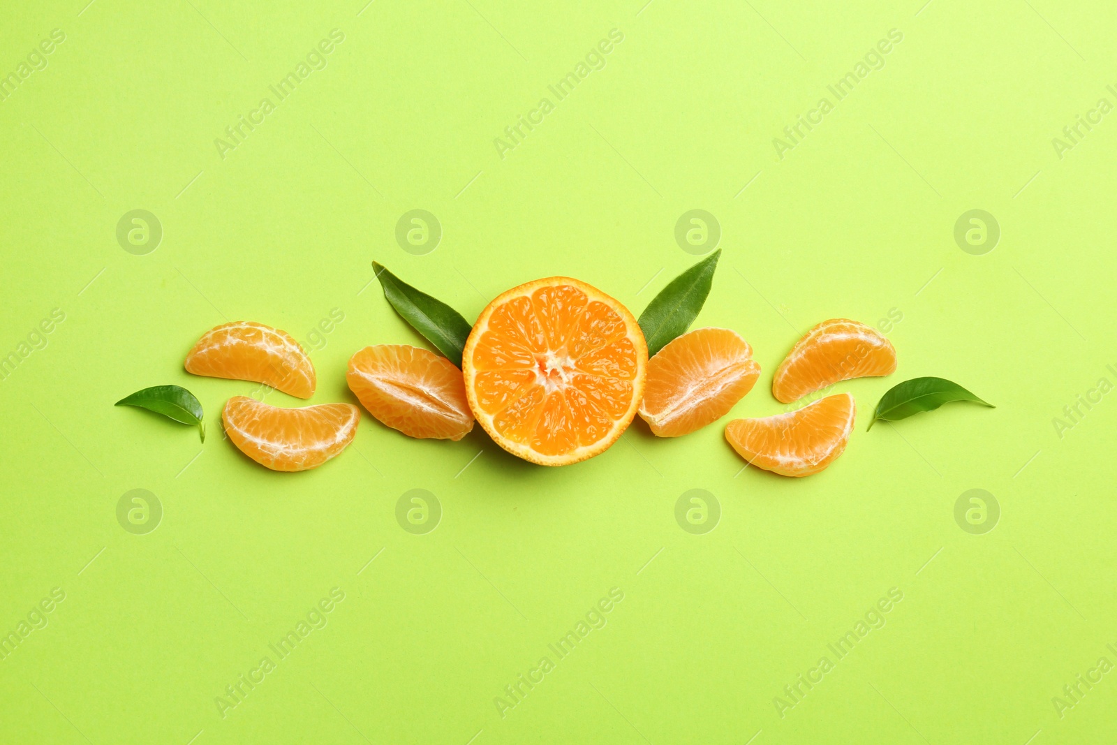 Photo of Composition with tangerines and leaves on color background, flat lay