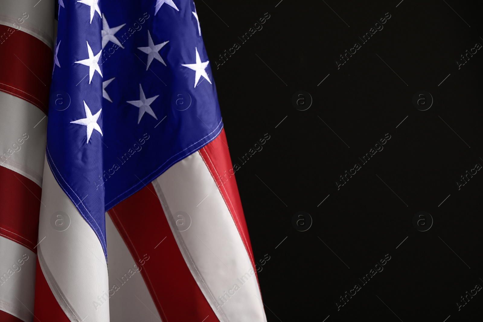 Photo of National flag of America on black background, space for text. Memorial day celebration