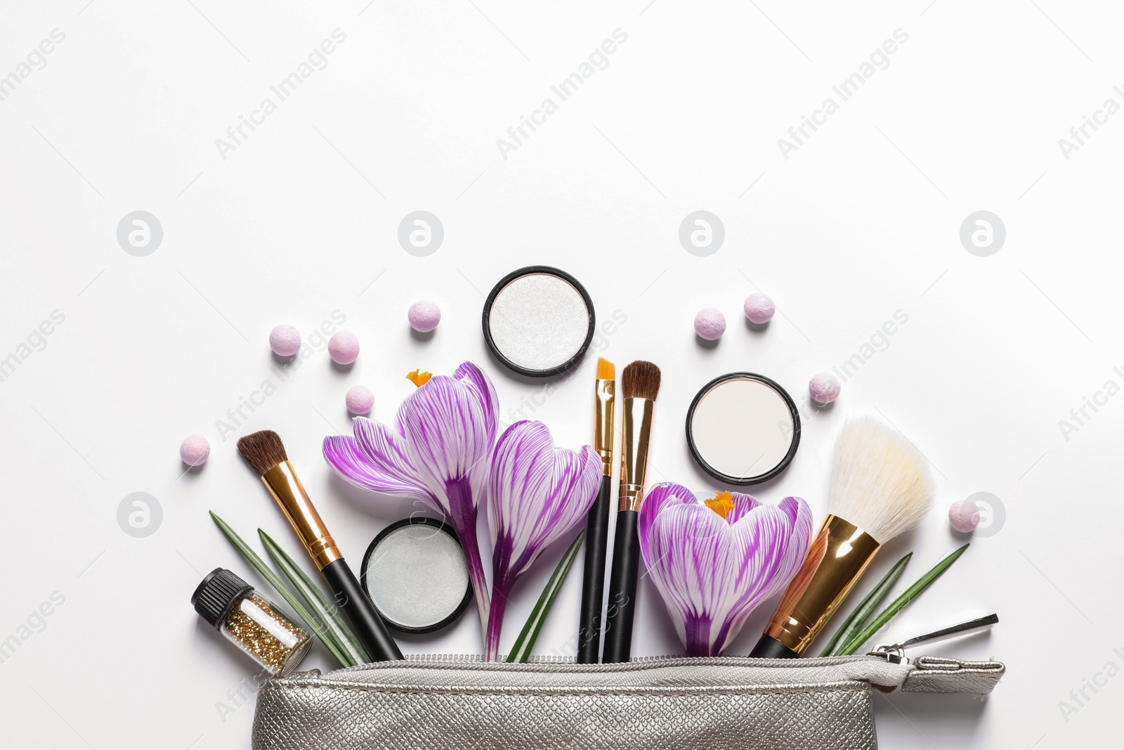 Photo of Makeup products, flowers and cosmetic bag on white background, top view