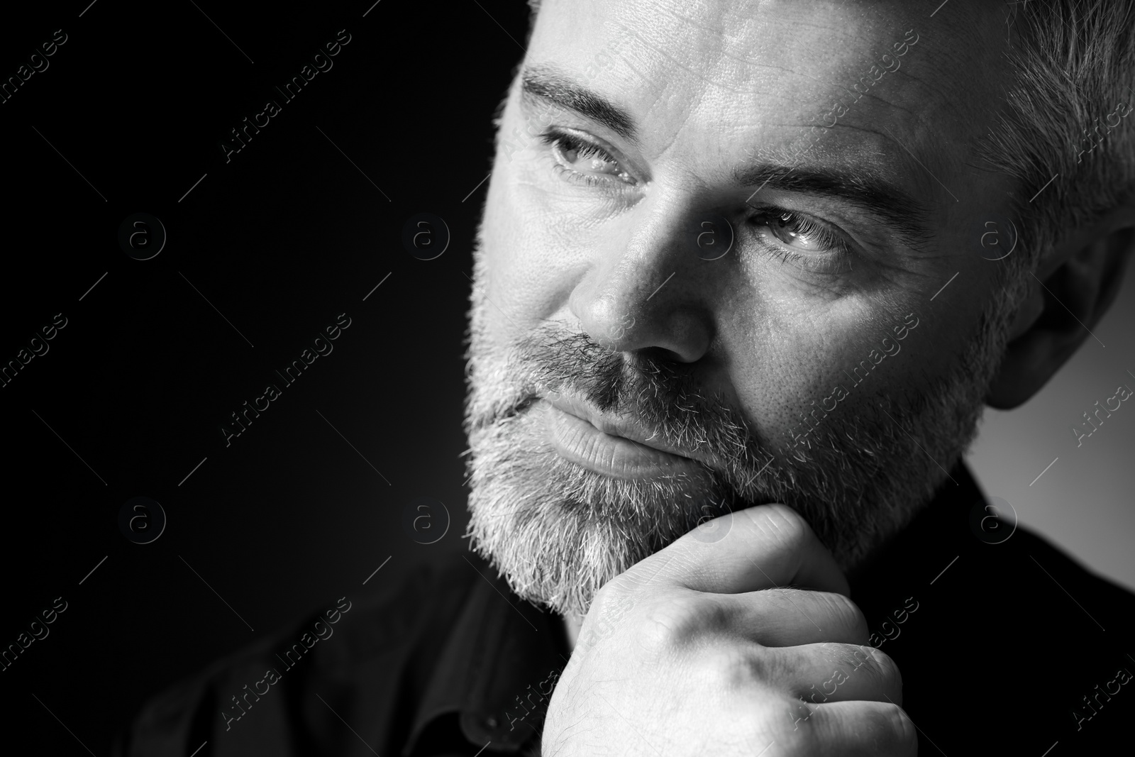 Photo of Portrait of handsome man on dark background, space for text. Black and white effect