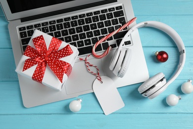 Photo of Flat lay composition with headphones on blue wooden background. Christmas music