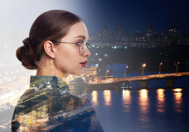 Double exposure of businesswoman and night city landscape