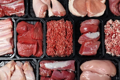 Photo of Containers with different raw meat, top view