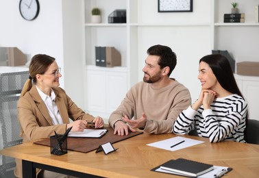 Photo of Couple having meeting with lawyer in office