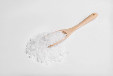 Photo of Wooden spoon with natural sea salt isolated on white