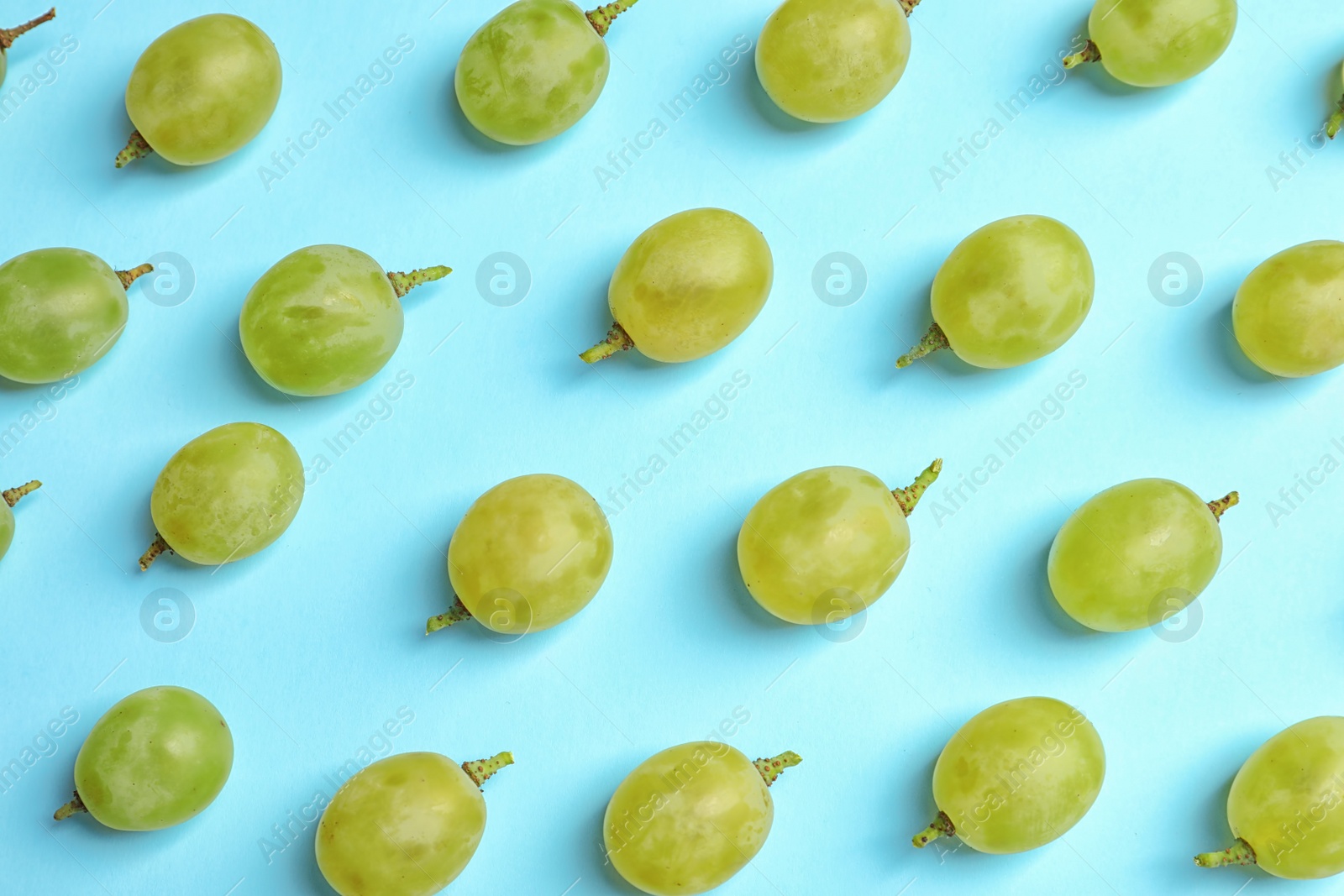 Photo of Fresh ripe juicy green grapes on color background, top view