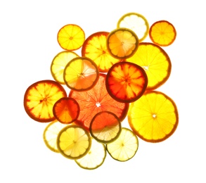 Illuminated slices of citrus fruits on white background, top view