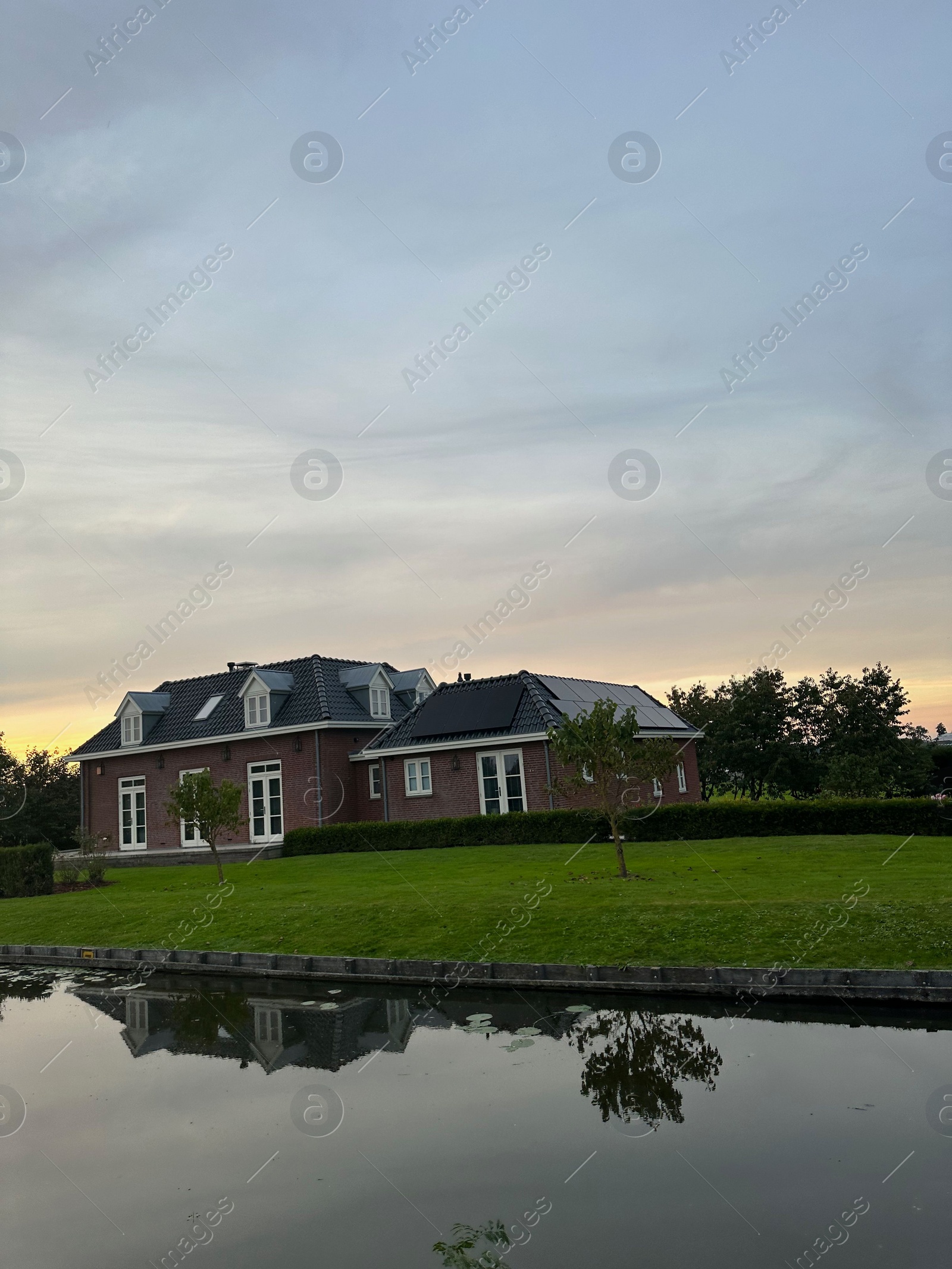 Photo of Buildings, lawn and canal under beautiful sky