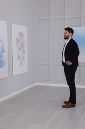 Photo of Young man at exhibition in art gallery