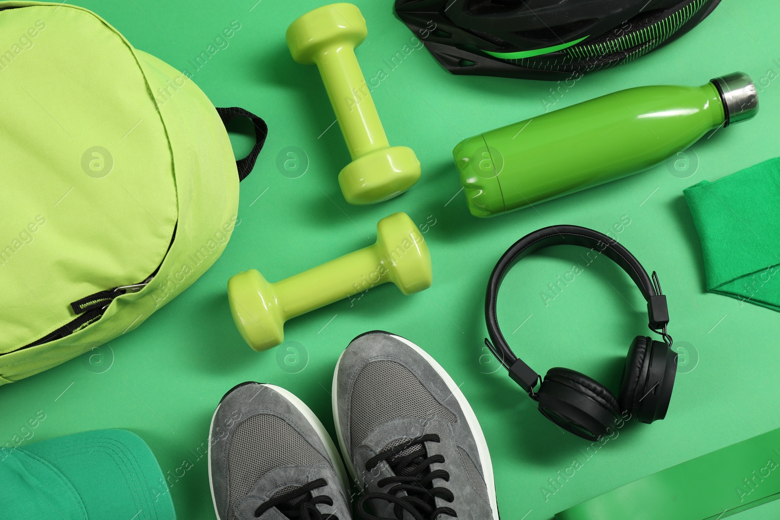 Photo of Different sports equipment on green background, flat lay