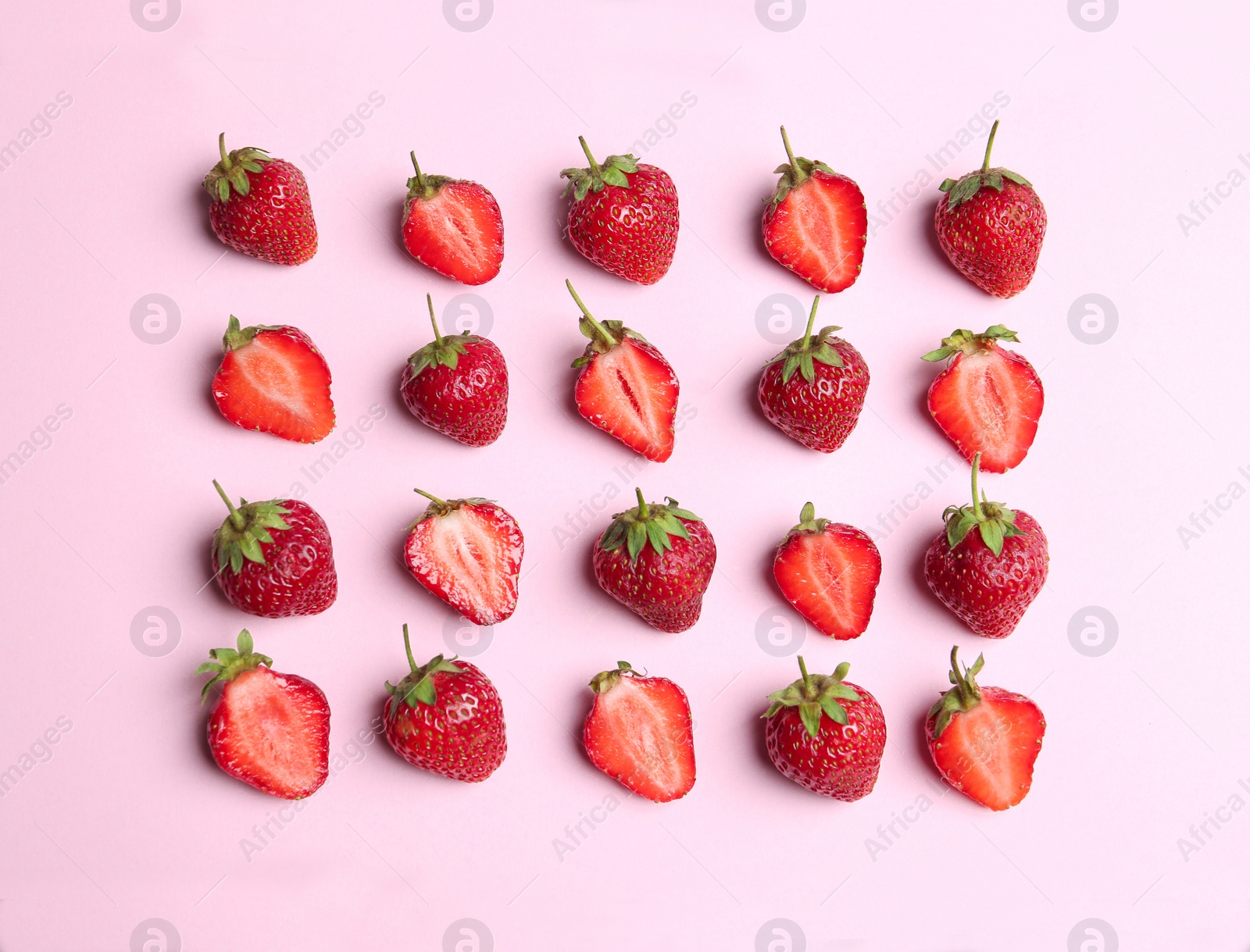 Photo of Tasty ripe strawberries on pink background, flat lay