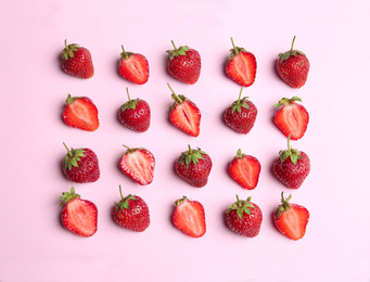 Photo of Tasty ripe strawberries on pink background, flat lay