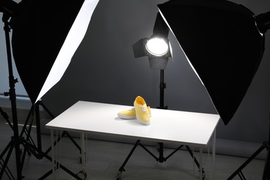 Photo of Professional photography equipment prepared for shooting stylish shoes in studio