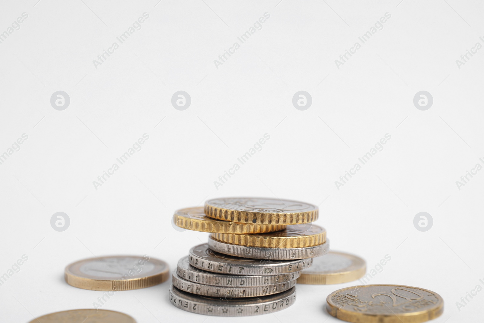 Photo of Many Euro coins on white background, closeup. National currency