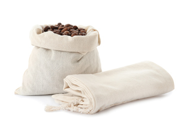 Photo of Cotton eco bag with coffee beans and empty one on white background